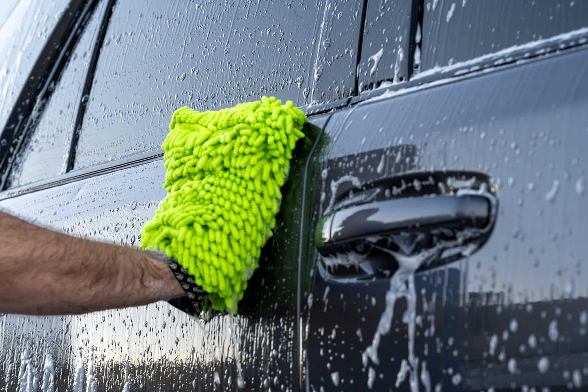 Hand washing SUV with microfiber mitt during mobile auto detailing in Mesa AZ